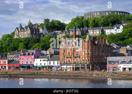 Shops and McCaig's Tower on Battery Hill overlooking the city Oban, Argyll and Bute, Scotland, UK Stock Photo