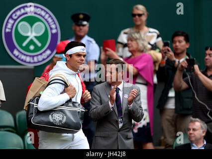 Milos Raonic walks out onto court for his match against Roger Federer on day nine of the Wimbledon Championships at The All England Lawn Tennis and Croquet Club, Wimbledon. Stock Photo