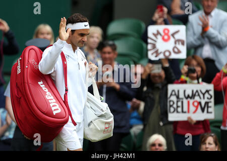 Roger Federer walks out onto court for his match against Milos Raonic on day nine of the Wimbledon Championships at The All England Lawn Tennis and Croquet Club, Wimbledon. Stock Photo