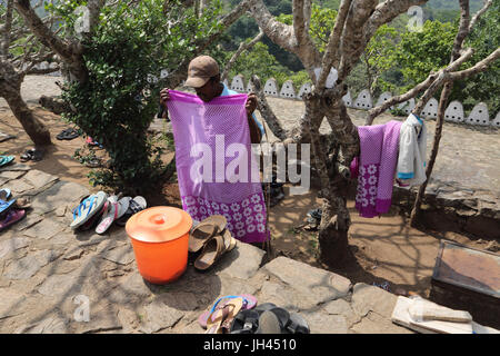 Dambulla Sri Lanka Golden Temple Man Looking After Flip Flops After People Take Them Of To Go Into Temples Stock Photo