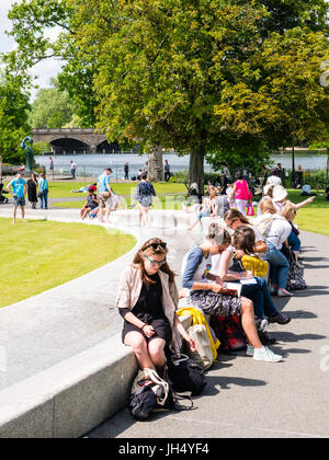 People Enjoying Sunshine, Princess Diana Memorial Fountain, Hyde Park, London, England Stock Photo
