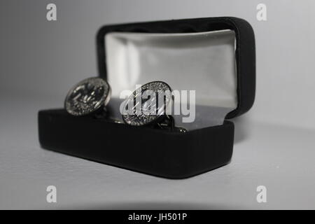 Silver cufflinks in a box Stock Photo