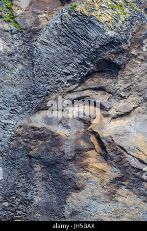 Contrasting rock formations on the exposed cliffs at Reynisfjara beach in Iceland Stock Photo