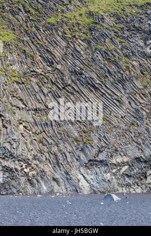 Exposed basalt formations on the Reynisfjara black sand beach in Iceland Stock Photo