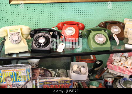 old phones, antique phones, phones on display, telephones, old fashioned phones, trendy interiors, trends, kitsch, antiques, second hand, charity shop Stock Photo