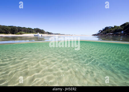 An under over split image of a beautiful, pristine beach scene with crystal clear turquoise water. Stock Photo