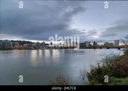 Portland Oregon downtown city skyline and Hawthorne Bridge over Willamette River waterfront during evening Stock Photo
