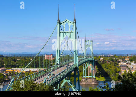 St Johns Bridge over Willamette River and Cathedral Park in Portland Oregon on a blue sky sunny day Stock Photo