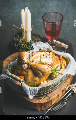 Christmas table set with oven roasted whole chicken and wine Stock Photo