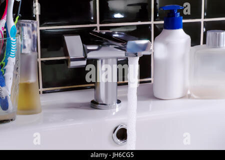 Modern water tap, running water and  hygiene objects. Bathroom scene