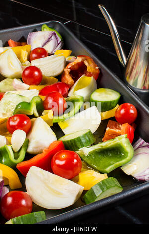 A tray of chopped  fresh vegetables, ready to be oven roasted Stock Photo