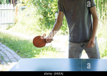 A young man playing ping-pong or table tennis Stock Photo