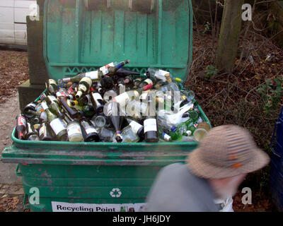 alcohol bottles recycling dumpster beer wine lager cider Stock Photo