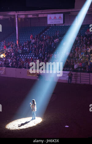 Woman singing at rodeo Stock Photo