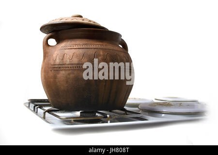 Traditional clay pot on the stove.  Isolated on white background. Stock Photo