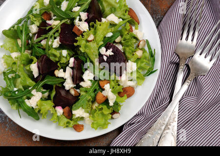 Salad vinaigrette with beets, lettuce, arugula, feta, and almonds Stock Photo