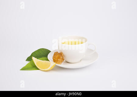 Freshly made  tea with aromatic lavender in white porcelain teacup decorated with fresh sage, lavender and flowers. Stock Photo