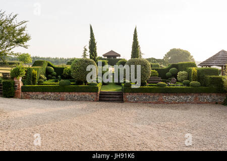 Brick wall and stairs in hedge garden Stock Photo