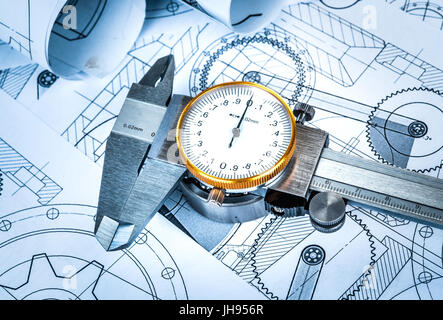 Metal vernier caliper and Ball bearings on technical drawing a blue toning Stock Photo