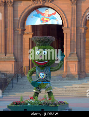 The 2014 Commonwealth Games mascot Clyde at his post games resting place Glasgow Kelvingrove museum with superhero superman materializing his ego Stock Photo