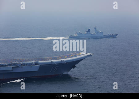 Aboard Liaoning Aircraft Carrier. 13th July, 2017. A flotilla including China's aircraft carrier Liaoning (Bottom) embark on a new training mission upon arrival at an unidentified sea area, July 13, 2017. Chinese aircraft carrier formation conducted coordination training on Thursday. Credit: Zeng Tao/Xinhua/Alamy Live News Stock Photo