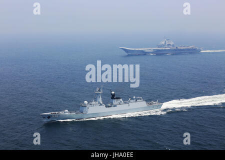 Aboard Liaoning Aircraft Carrier. 13th July, 2017. A flotilla including China's aircraft carrier Liaoning (Top) embark on a new training mission upon arrival at an unidentified sea area, July 13, 2017. Chinese aircraft carrier formation conducted coordination training on Thursday. Credit: Zeng Tao/Xinhua/Alamy Live News Stock Photo