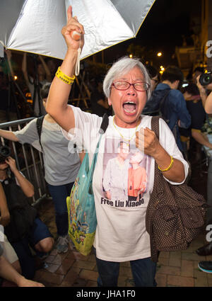 July 14, 2017 - Hong Kong, Hong Kong SAR, China - Protester ALEXANDRA WONG mourns, following the death in China of Nobel peace prize laureate Lui Xiaobo during a protest at the Central People's Government in the Hong Kong Special Administrative Region Liaison Office. Liu Xiaobo, the renegade Chinese intellectual who kept vigil at Tiananmen Square in 1989 to protect protesters from encroaching soldiers, promoted a pro-democracy charter that brought him a lengthy prison sentence and was awarded the Nobel Peace Prize while locked away, died under guard in a hospital on Thursday. He was 61. (Credi Stock Photo