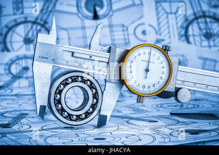 Metal vernier caliper and Ball bearings on technical drawing a blue toning Stock Photo