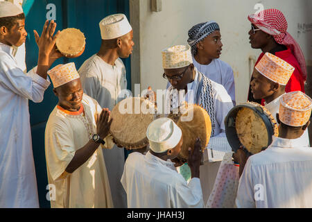 Procession (Zefe) along the streets of Lamu old town to celebrate Maulidi festival, the birth of the prophet Mohammed, Lamu island, Kenya Stock Photo