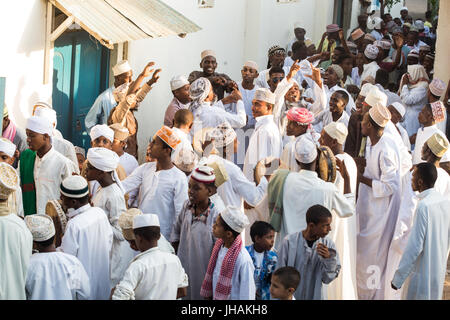 Procession (Zefe) along the streets of Lamu old town to celebrate Maulidi festival, the birth of the prophet Mohammed, Lamu island, Kenya Stock Photo