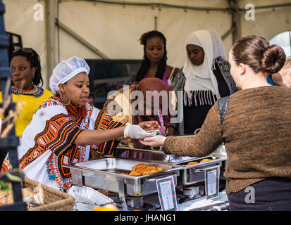 Ladies serving African food at Manx Food & Drink Festival at Willa Marina Stock Photo