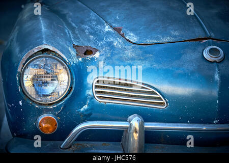 Vintage weathered unrestored blue German classic car with rust hole and tons of character Stock Photo
