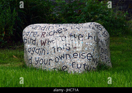 Words of a poem by Gwyneth Lewis inscribed in mosaic on a boulder at Strata Florida Abbey, Near Tregaron, Ceredigion, Wales Stock Photo