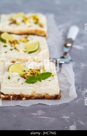 Raw pistachio, coconut and lime cheesecakes. Love for a healthy vegan food concept. Stock Photo