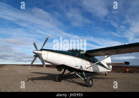 Light aircraft on the runway by Seal River Heritage Lodge in Manitoba, Canada. The de Havilland plane transports people and luggage between Churchill  Stock Photo