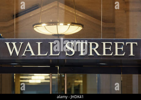 Wall Street golden letters sign at building entrance near Stock Exchange financial district in New York Stock Photo