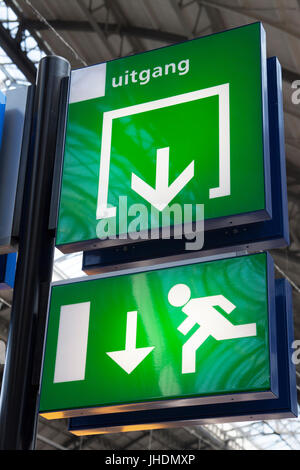 Green exit sign on a station Stock Photo