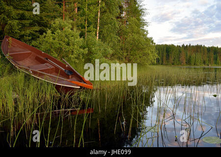 A rowing boat on the lake shore. Stock Photo