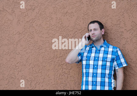 Man on his cell phone having a serious conversation. Stock Photo