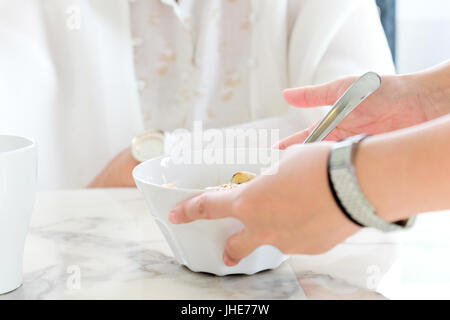 carer bringing meal to senior,meal time. part of senior woman with breakfast, Senior healthy eating Stock Photo