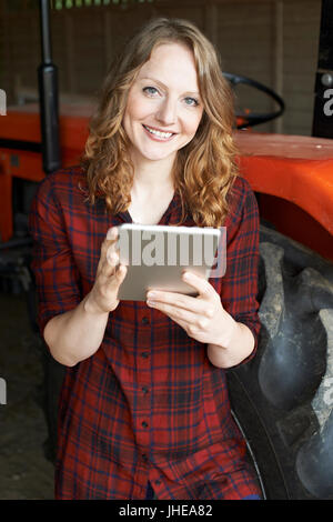 Female Agricultural Worker On Farm Using Digital Tablet Stock Photo