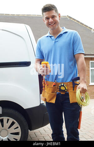 Portrait Of Electrician With Van Outside House Stock Photo