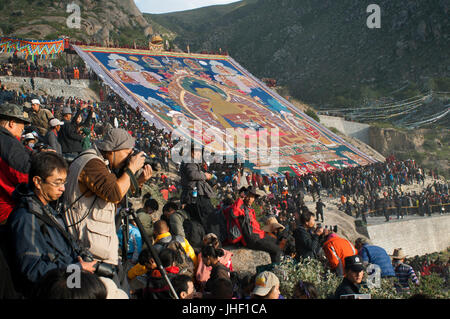 Giant silk Tangka unveiled at Drepung monastery during the Yogurt Festival or also called Shoton Festival, Lhasa, Tibet. Stock Photo
