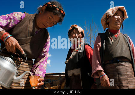 A family celebrates the graduation of a relative in the village of Bainans, located along the road separating Shigatse from Gyantse, Tibet, China. Stock Photo