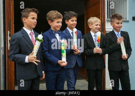 NANDLSTADT, GERMANY - MAY 7, 2017 : A group of young boys holding candles lined up and posing for photographing at their first communion in Nandlstadt Stock Photo