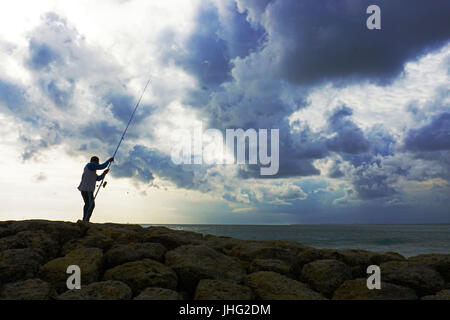 Fishing in cloudy afternoon. Stock Photo