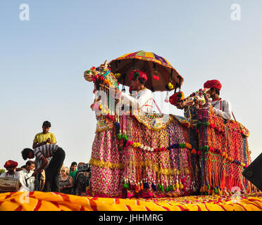 PUSHKAR, INDIA - MAR 7, 2012. Rajasthani folk dancers in colorful ethnic attire perform in Pushkar, India. Pushkar is known around the world for its P Stock Photo