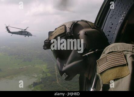 A U.S. crew chief door gunner scans the Sri Lankan horizons from a U.S. Air Force HH-60 Pave Hawk helicopter during tsunami relief operations December 17, 2003 in Sri Lanka.    (photo by Val Gempis  via Planetpix) Stock Photo