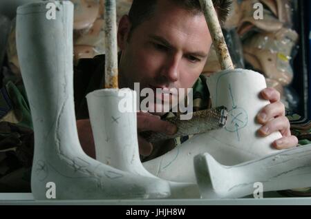 A U.S. soldier uses a sander to adjust an orthotic plaster mold for limb prosthesis at the Yokota Air Base April 25, 2004 in Tokyo, Japan.    (photo by Val Gempis via Planetpix) Stock Photo