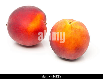 Two uncut, whole, ripe peaches fruit over white background Stock Photo